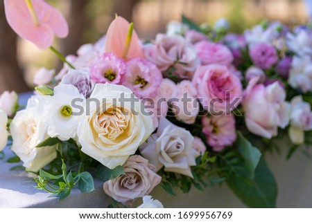 Bouquets of fresh flowers decoration of the festive table. Celebrating an open air party. Decor Details.