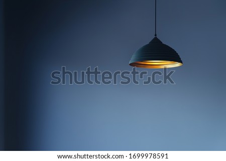 vintage style hanged ceiling lamp warm orange tone light color bulb light with dark blue tone dirty concrete background wall
 Royalty-Free Stock Photo #1699978591