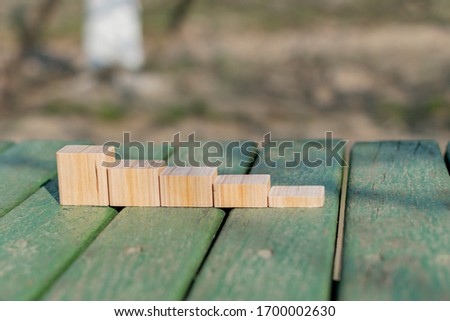 Collage of wooden blocks on a decorative background