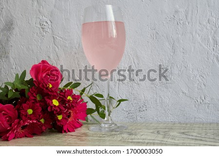 Pink cake, rose wine and bouquet of lovely pink flowers. Perfect for Mother's Day. Image with some copy space.