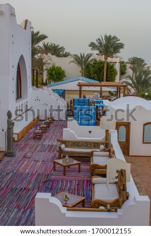 Pictures view of traditional Sharm el Sheikh houses on small street with palm trees.Extremely beautiful view of the resort and Luxury vacation in Egypt, Africa.Travel summer holiday background concept