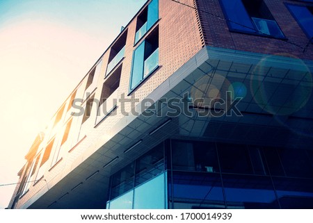 Modern apartment building flat estate concept. Outdoor residential facility at sunset and sunrise. Retro stylized colorful tonal filter effect.