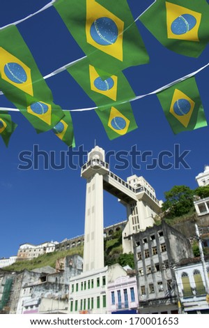 Brazilian flag bunting flying over sunny view of the elevator in Salvador Brazil