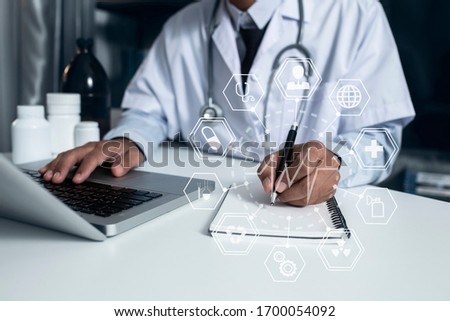 Double exposure of healthcare And Medicine concept. Doctor using modern computer with tablet and modern virtual screen interface, Medical science and biotechnology.