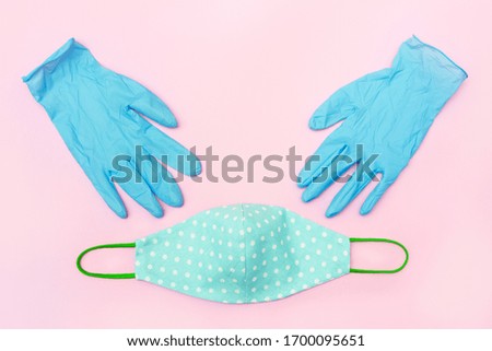 diy face mask for viruses and latex medical gloves. pink background