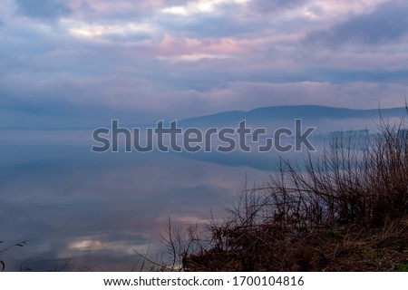 Scenic colorful sunset at the sea coast. Good for wallpaper or background image Radiant sea beach sunset Panoramic photo of beautiful sunset Lake Bracciano Italy