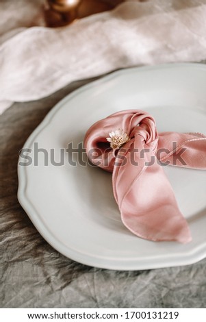 Elegant table photography decoration with special silk ribbon props on the plate. Blossom flower decorative for wedding and other special events.