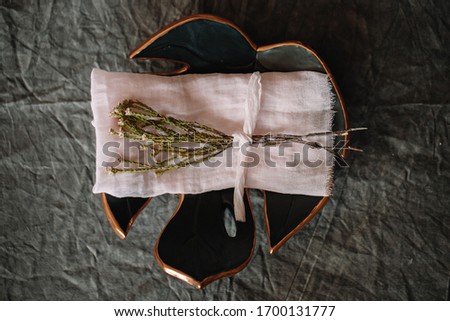 Special silk ribbon focus view on leaf shape plate with fabric cloth made of wool. Perfect props for table decoration. A decorative light peach color motif for wedding and other event.
