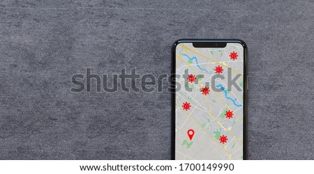 Smartphone with the Coronavirus COVID-19 Tracking App with Data Protection showing your Location and Infected Persons. Fight the Spread of Coronavirus concept. Royalty-Free Stock Photo #1700149990