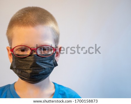 Two boys in dirty medical masks are quarantined at home. Children cough hard and get dirty with masks quickly. concept of fight against coronavirus epidemic and proper prevention of infections