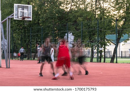 Young people enthusiastically play street basketball 