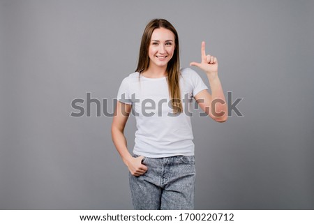 woman showing two fingers isolated on grey background