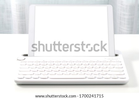 Digital tablet with isolated screen on table close up. Selective focus image.