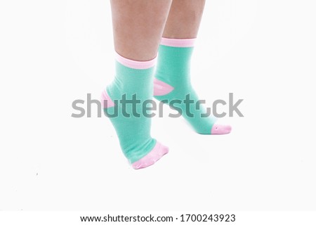Female legs with color socks fashion on background

