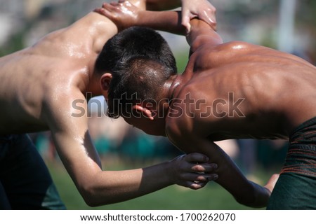 Oily wrestling sports competition photos.