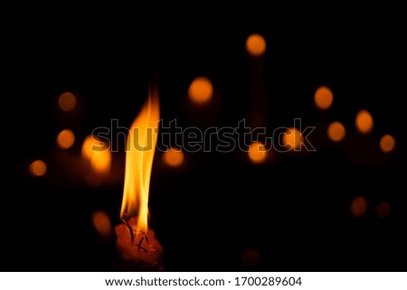 candles and lights  on a black background with bokeh lights.