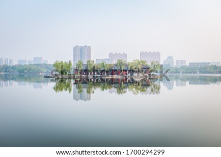 Central island in Daming Lake. This building called Lixia Pavilion, it is  a landmark for Jinan. Royalty-Free Stock Photo #1700294299