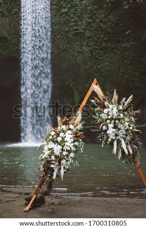 Boho style wedding arch. Boho wedding and wows renewal on the Tibumana waterfall, Bali, Indonesia