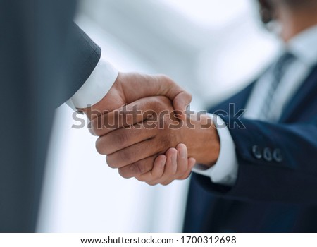 Two businessman shaking hands greeting each other Royalty-Free Stock Photo #1700312698