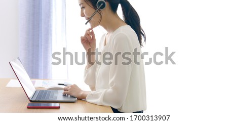 Working asian woman in the living room. Telemeeting. Video conference. Remote work. Royalty-Free Stock Photo #1700313907