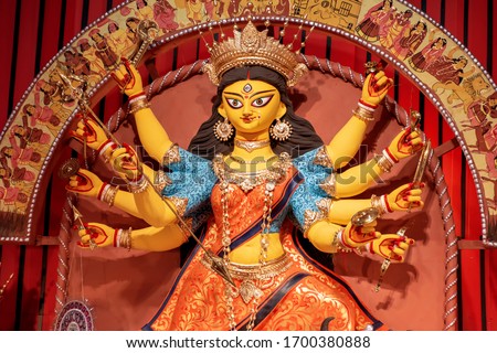 Goddess Durga idol at decorated Durga Puja pandal, shot at colored light, in Kolkata, West Bengal, India. Durga Puja is biggest religious festival of Hinduism and is now celebrated worldwide. Royalty-Free Stock Photo #1700380888