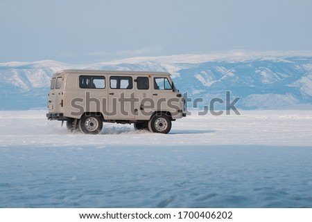 Car "UAZ" rides on lake Baikal
