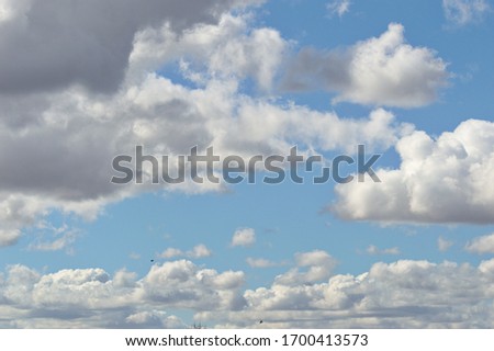 blue sky with white and grey clouds