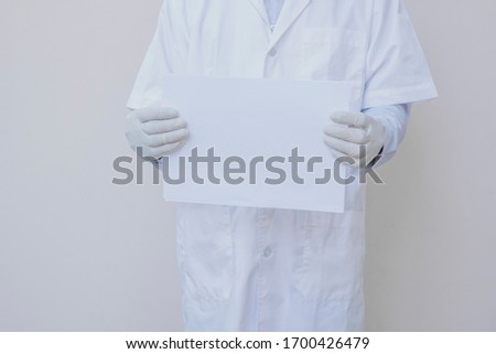 Doctor holding blank white sign for communication to people in prevention awareness of corona virus pandemic and health care 