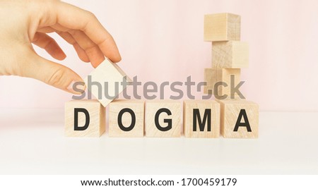 DOGMA word written on wood block on a light background