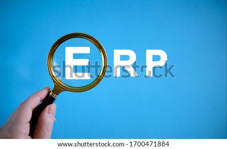 ERP - text with a magnifying glass on a blue background