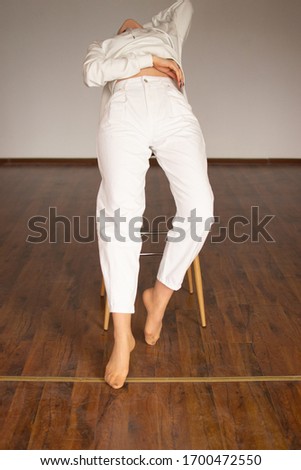 White jeans (pants) on the model.