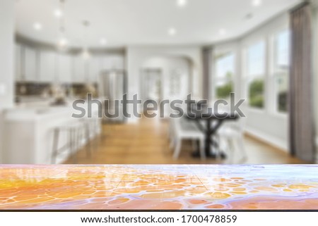 Marble stone table top (kitchen island) on blur kitchen interior background - can be used for display or montage you products