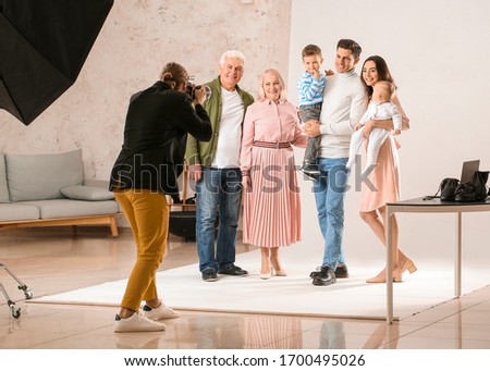 Photographer working with family in studio