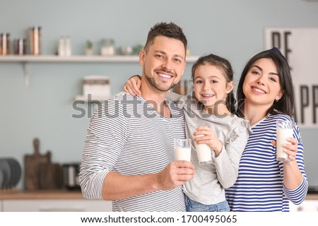 Family drinking milk at home Royalty-Free Stock Photo #1700495065
