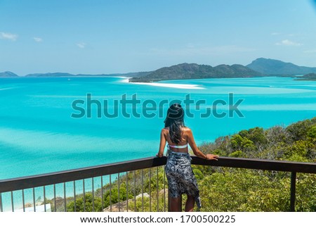 Woman & Aqua ocean sea view. Looking at Whitehaven beach aerial view, Whitsundays. Turquoise ocean, white sand. Travel, holiday, vacation, paradise. Shot in Hill Inlet, Queenstown, Australia.