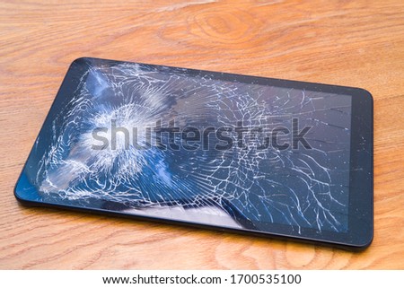 Tablet with cracked display on the desk