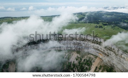 Aerial view of a crater above the morning fog in Switzerland