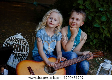boy with a guitar, children in the park, holiday