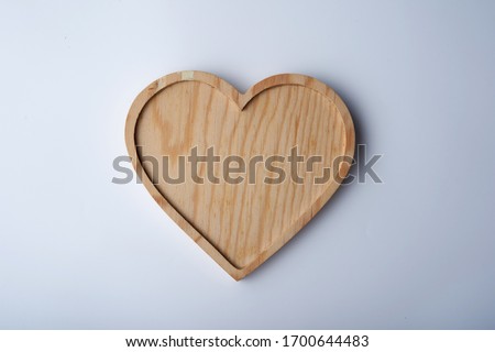 Heart shape wooden tray on white background      