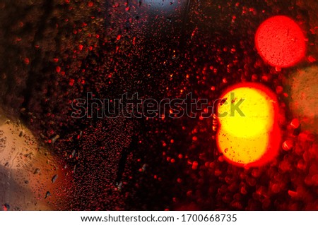 Raindrops on the glass window at night