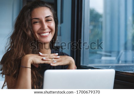 Self-quarantine, personal growth and development concept. Smiling woman working with computer remote home, employee get ready for online video-call interview, learning new skills while on lockdown Royalty-Free Stock Photo #1700679370