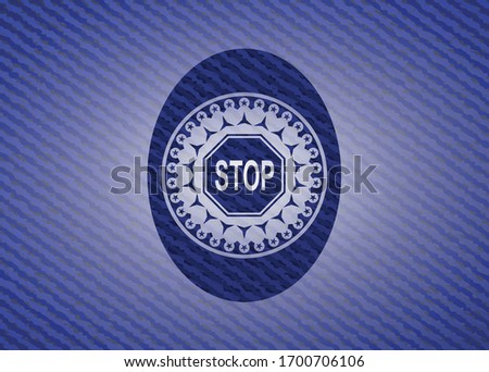 stop icon inside badge with denim background