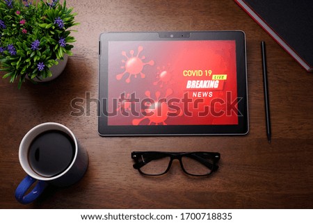 World emergency Covid-19 Breaking news live  concept with worlmap background on PC Tablet screen
