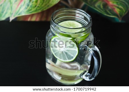Lemon grass, citrus slices, honey, and water on the glass. it is infused water,good water for health.