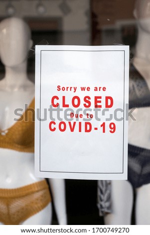 Closeup of information sign on the window of the underwear store front : Sorry we are Closed due to covid-19