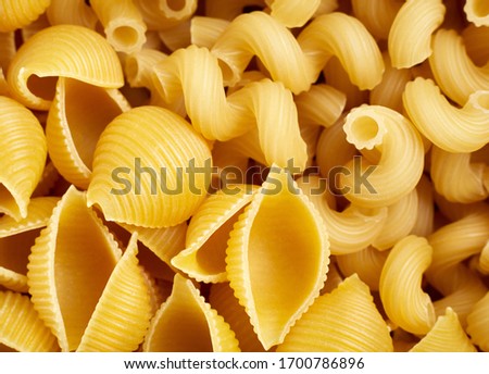 Classic durum wheat pasta isolated on white background. Food and drink concept - various uncooked pasta on white background. Variety of types and shapes of dry Italian pasta