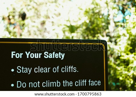 Sign Warning to do not climb the cliff face 