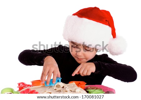 Little Boy in Santa Hat Prepared Dough with Colored Pastry Cutters isolated on white background 