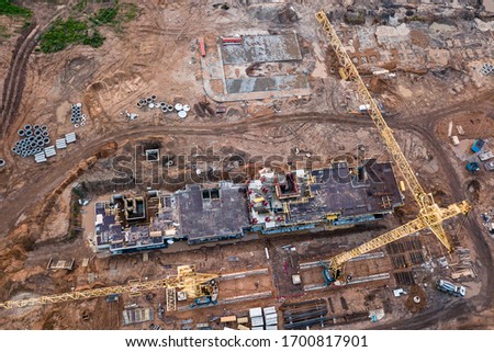 Foundation pit. Construction of multi-storey country house. Construction site. Zero cycle construction work. Country Development Project. crane and foundation pit aerial view