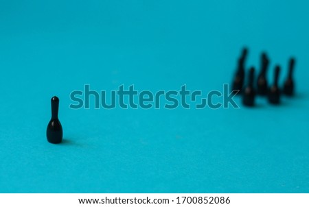 Conceptual representation of social distancing with black figurines  Royalty-Free Stock Photo #1700852086